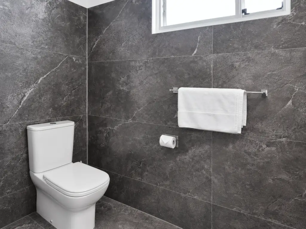 Private bathroom — toilet and towel rail