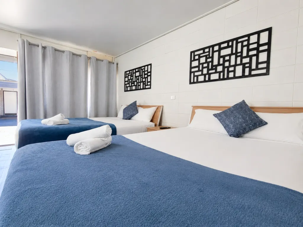 Deluxe Family Room — beds with navy accents