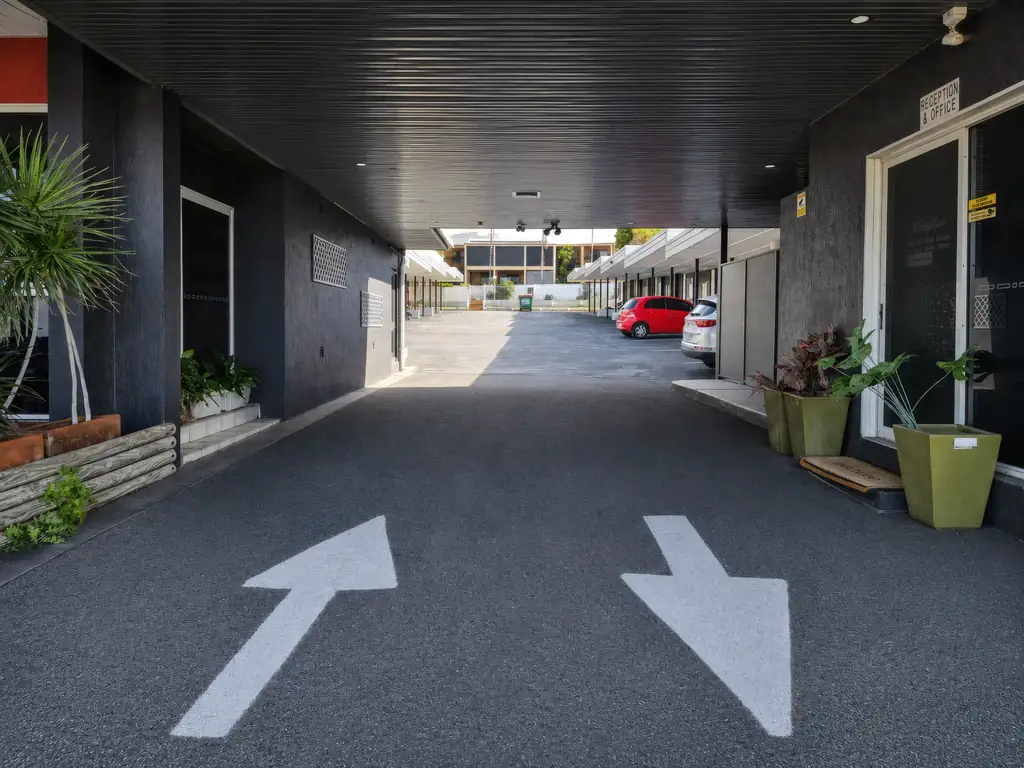 Covered drive-through entrance leading to reception and office