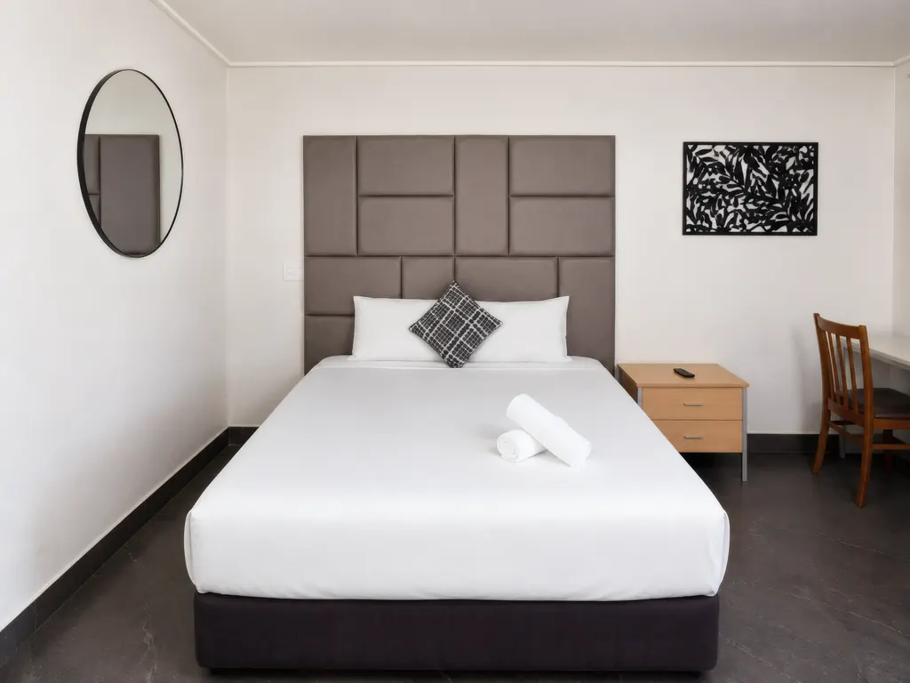 Deluxe King Room — bed and wall art detail