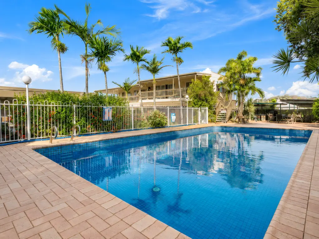 Saltwater pool and palm-lined courtyard at Gladstone CBD Motel