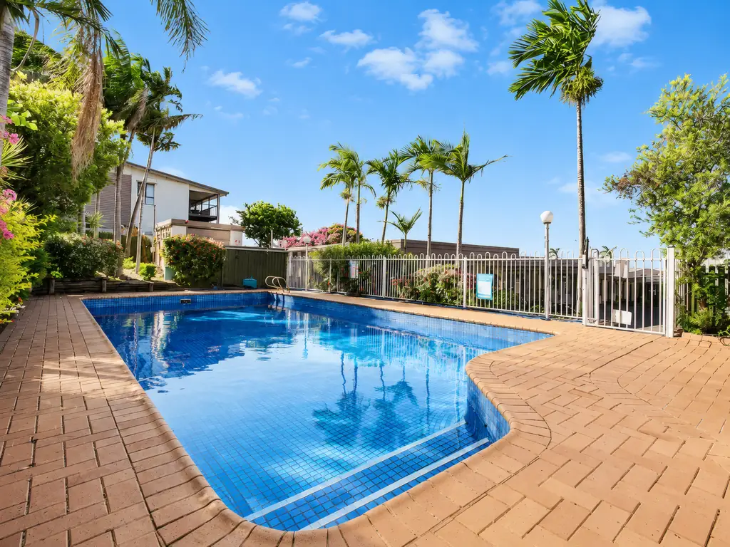 Saltwater pool with palms and paving in the motel grounds