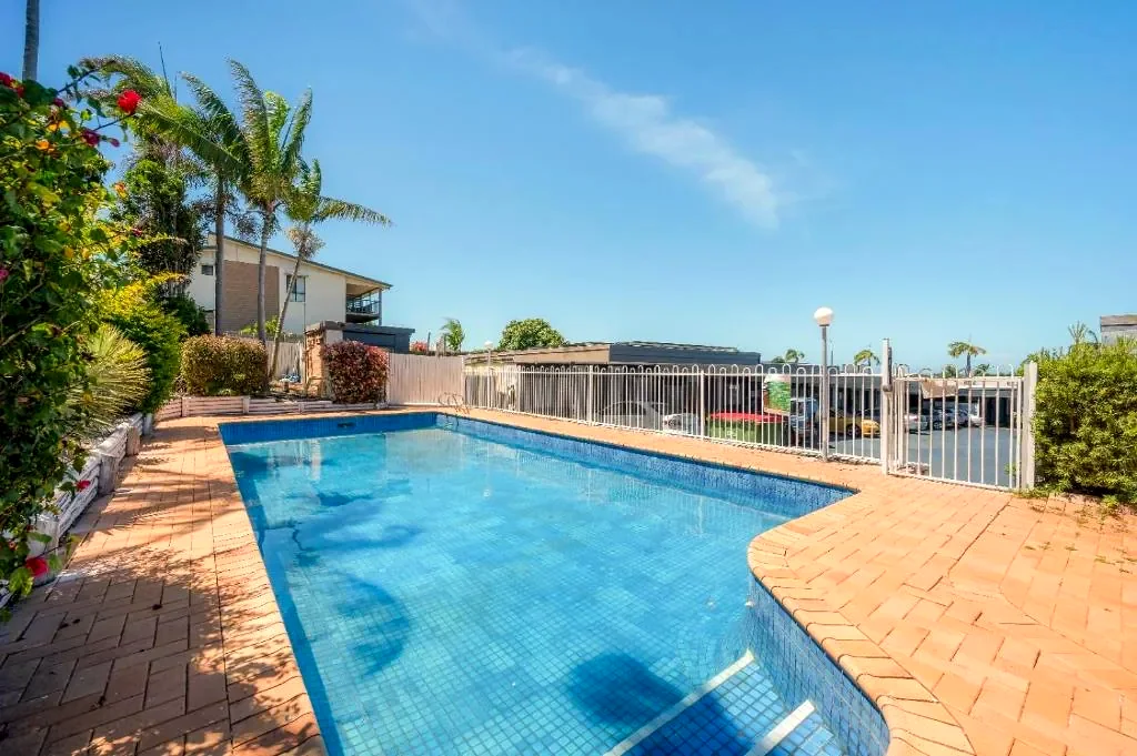 Saltwater pool with palms and brick paving in the motel grounds